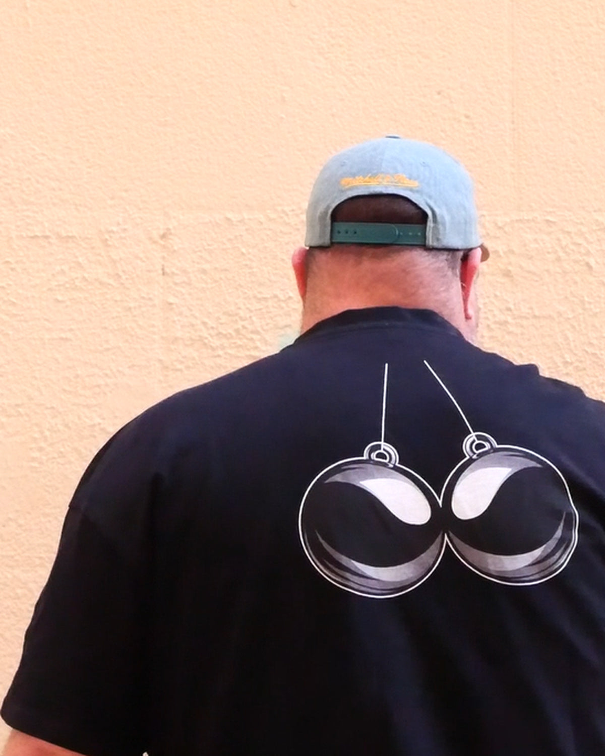 BBA heavyweight oversized tee in Midnight Black, back view with signature orb graphic