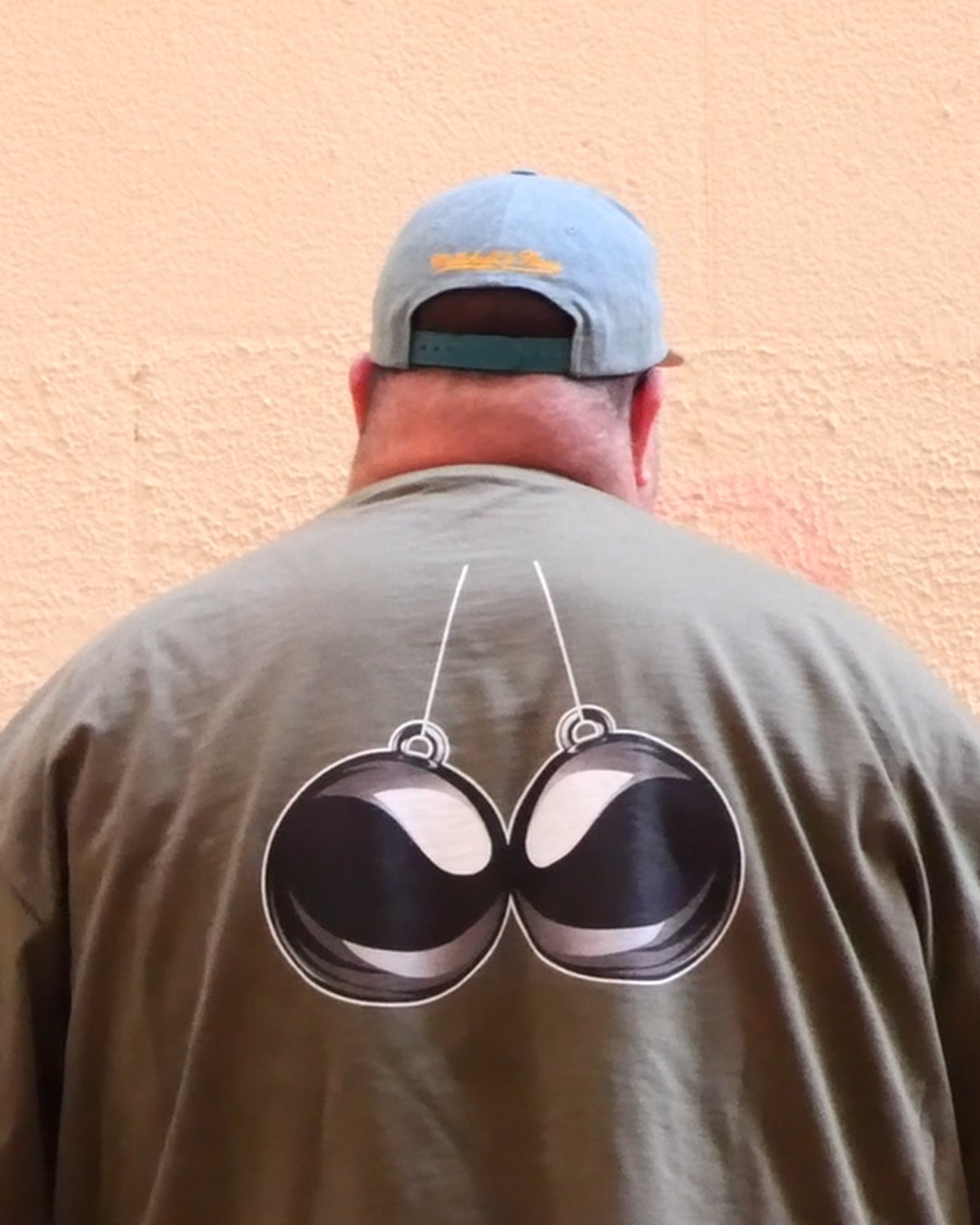 BBA heavyweight oversized tee in Olive Green, back view with signature orb graphic